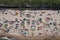 MIELNO, POLAND - 14 JULY 2019 - Drone aerial top down view on sunny beach with sunbathers tourists at baltic sea on Mielno city