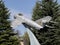 MiG-17 aircraft on a pedestal against a sky background. Front view