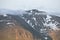 Mighty mountain peak with clouds and snow patches