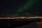 Mighty northern light dancing over snowy mountain peak in northern norway on the whale island