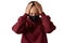 Migraine. Young european woman wears face mask and burgundy sweatshirt, suffers from headache, has symptoms of virus disease,