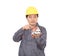 A migrant worker in a yellow hard hat with a model house in his finger