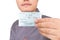 Migrant workers in front of a white background show that they have just grabbed a train ticket to go home for the New Year