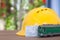 Migrant workerâ€™s yellow helmet, model train and a train ticket