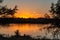 Migrating birds on the lake at dusk with ripples on the lake