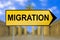 Migration traffic sign with blurred Berlin background