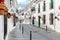Mijas white washed street, small famous village in Spain. Charming empty narrow streets with New Year decorations