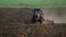 Mikhailovsk, Stavropol region, Russia - April 25 2022: Agricultural red small tractor in the field plowing, works in the
