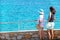 Mil palmeras, Spain, August 3, 2019: Back view of two tourists looking at horizon over the sea on summer vacations