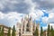 Milan Cathedral against a cloudy sky in summer.