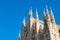 Milan Cathedral spires against blue sky
