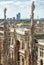 Milan Cathedral spires overlooking the Galleria Vittorio Emanuele II, Milan, Italy. Scenery of luxury Gothic roof with statues