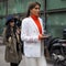 MILAN - FEBRUARY 24, 2018: Fashionable woman posing in the street for photographers before ARMANII fashion show