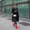 MILAN - FEBRUARY 24, 2018: Fashionable woman posing in the street for photographers before ARMANII fashion show