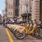 Milan, Italy - 09 May 2018: Yellow BikeMi bicycles for rent in a parking spot