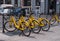 Milan, Italy - 09 May 2018: Yellow BikeMi bicycles for rent in a parking spot
