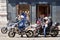 Milan, Italy - July 20, 2020. Motorbike commuting. Man in mask riding motorbike in busy city street traffic