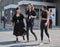 MILAN, ITALY -JUNE 18, 2018: Three women walking in the street after HUNTING WORLD fashion show