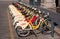 Milan, Italy - May 25, 2016: Yellow BikeMi bicycles for rent in a parking spot.