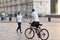 Milan, Italy - May 4, 2020: Man riding bicycle on Duomo square. Italy enters second phase of coronavirus lockdown.