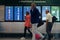 MILAN, ITALY - OCTOBER 9, 2017: Airport, people go to the flight departure boards in background