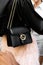 Milan, Italy - September, 21, 2022: Stylish woman wearing black dollar calfskin small interlocking G shoulder bag from