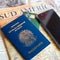 Milan, Italy â€“ July 20, 2018 : A Brazilian passport and a smartphone over a tourist magazine of South America, on a light