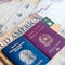 Milan, Italy â€“ July 20, 2018 : An Italian and brasilian passports with a smartphone over a tourist magazine of South America and