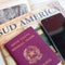 Milan, Italy â€“ July 20, 2018 : An Italian passport with a smartphone over a tourist magazine of South America, on a light