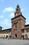 Milan Sforza Castle medieval tower and fortifications with internal garden, meadow of poppies and red brick ancient wall.