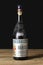 Milano, Italy, 21 January 2020: bottle of seasoned barolo year 1953 wine rest on a wooden table isolated on black background with