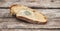 Mildew on a slice of bread, lying on a wooden surface. Stale bread, covered with mildew_