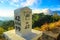 Milestone at the roadside with mountain landscape