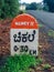 Milestone on a rural road at Chikhale village near Belgaum Karnataka