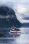 MILFORD SOUND NEW ZEALAND - AUGUST 30,2015 : tourist boat cruising in harbor of milford sound most popular natural traveling