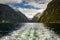 Milford Sound Piopiotahi World Heritage Site in Fiordland, New Zealand. Steep sided mountains soar above the turbulent waterline