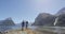 Milford Sound tourist couple hiking in New Zealand enjoying view of Mitre Peak