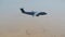 Military air freighter flying above desert location 4K