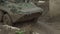 Military armored personnel carrier travels along the muddy road. Dirty armored vehicle