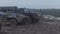 Military armored personnel carrier travels along the muddy road. Dirty armored vehicle