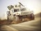 Military armored vehicle moving at a high rate of speed with motion blur over sand. Generic