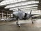 Military aviation arsenal inside a military hangar awaiting deployment. F 35 Fighter jet, stealth fighter and attack drone.