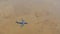 Military cargo aircraft flying over desert top view 4K