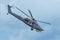 Military combat helicopter flies rapidly turning in the air