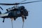 Military combat and war with helicopter flying into the chaos and destruction. Close up of Soliders leaving chopper on rope.