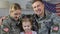 Military couple with daughter smiling in camera, american army, young family