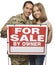 Military Couple Holding A For Sale By Owner Sign