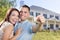 Military Couple with House Keys In Front of New Home