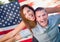 Military Couple Piggy Riding In Front of American Flag