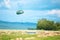 A military crate is being parachuted from a military cargo plane during a drill